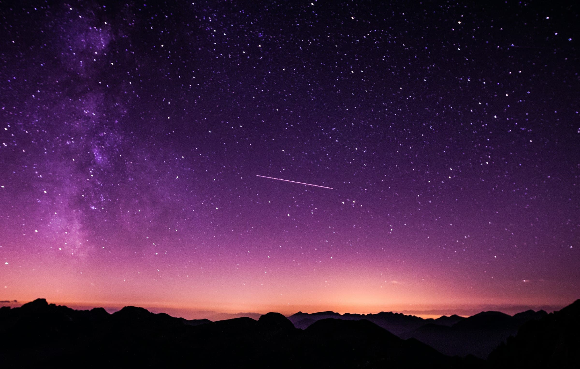 A night sky over a dark ridgeline.